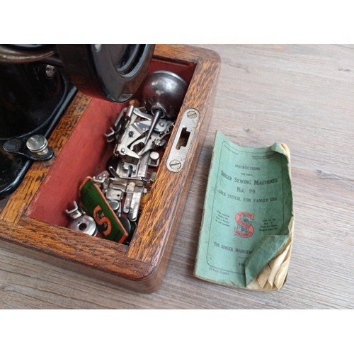 859 - A cased 1932 Singer 99K hand crank sewing machine with attachments and instruction manual