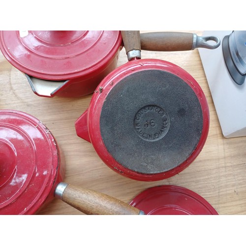 862 - Six items of French enamelled cast iron cookware, three Cousances lidded saucepans, one Le Creuset f... 