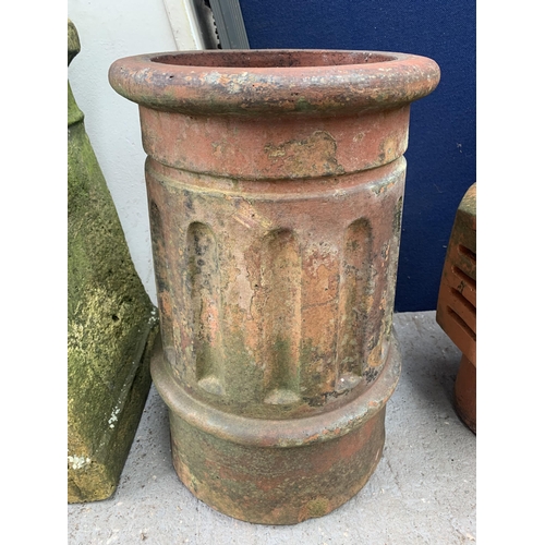 1024A - Four garden items, one cast stone chimney pot, two terracotta chimney pots and one terracotta cowl f... 