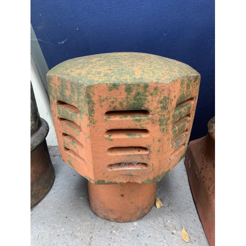 1024A - Four garden items, one cast stone chimney pot, two terracotta chimney pots and one terracotta cowl f... 