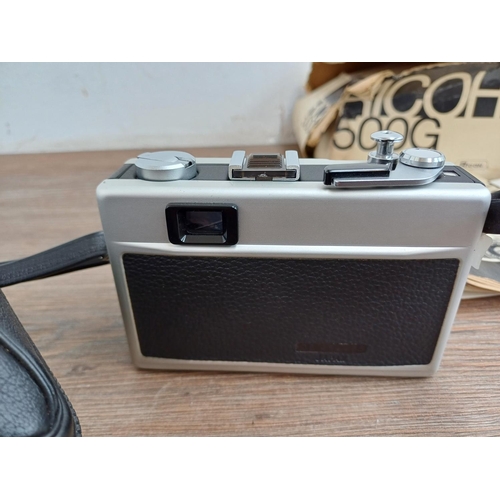 620 - Two items with instruction manuals, one boxed and cased 1970s Ricoh 500G 35mm compact coupled rangef... 