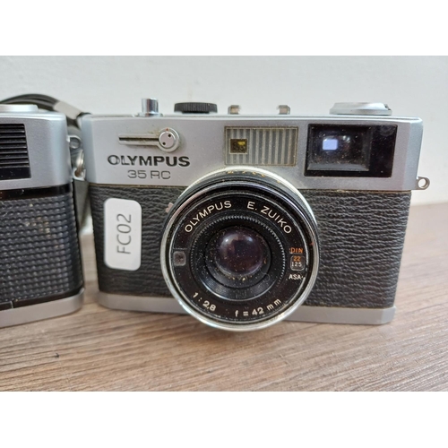 627 - Three Olympus 35mm compact cameras, one 35 RC fixed lens rangefinder, one cased Trip 35 fully-automa... 