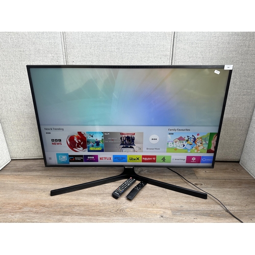 A Samsung UE43NU7400U 4K 43" smart TV with two remote controls