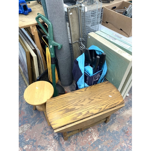 1029 - A large collection of house clearance items to include garden tools, chicken wire, fibrewood underla... 