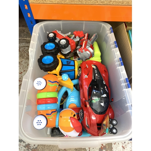 1031 - Two boxes containing toys and games to include Ferrari model vehicle, dolls house, JCB model vehicle... 