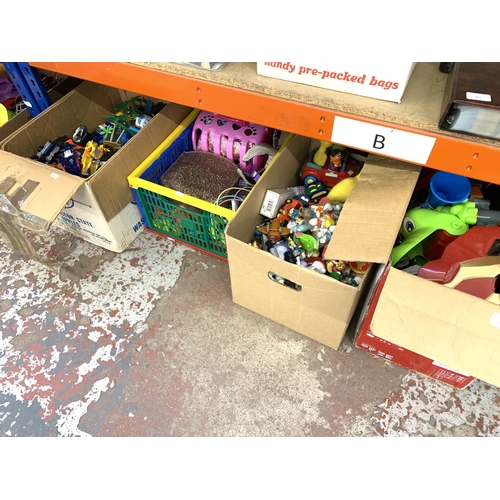 1032 - Four boxes containing toys and games to include Action figurines, Nerf guns, model vehicles etc.