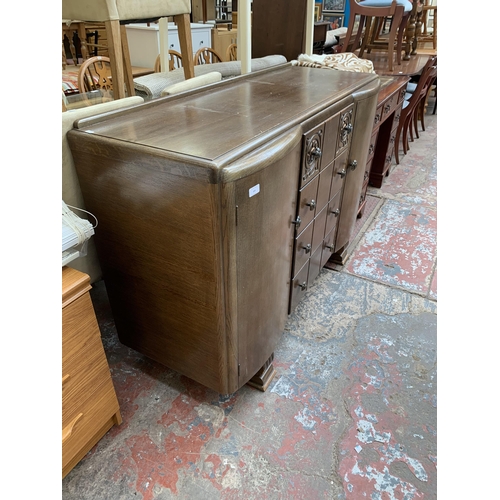 101 - A mid 20th century Art Deco style carved oak sideboard