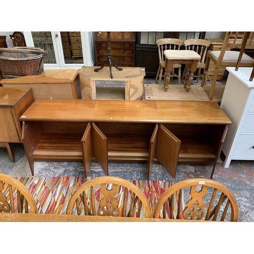 61 - A mid 20th century teak sideboard - approx. 58cm high x 200cm wide x 45cm deep