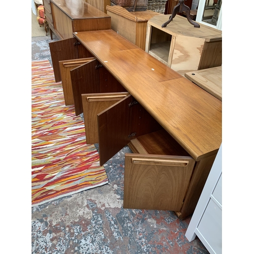 61 - A mid 20th century teak sideboard - approx. 58cm high x 200cm wide x 45cm deep