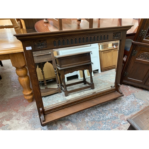 70 - An Old Charm carved oak framed bevelled edge overmantel mirror - approx. 91cm high x 108cm wide