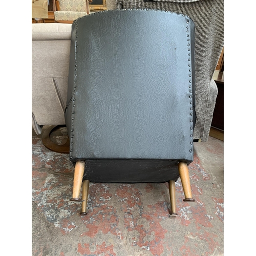 96 - A mid 20th century black vinyl upholstered armchair with floral cushion - approx. 92cm high x 80cm w... 