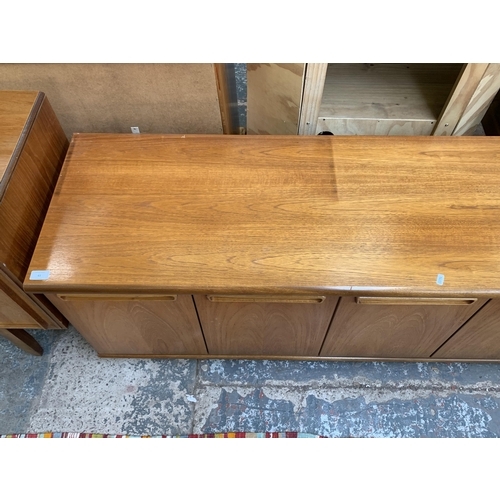 61 - A mid 20th century teak sideboard - approx. 58cm high x 200cm wide x 45cm deep