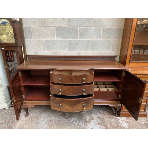 6 - An Edwardian carved mahogany bow fronted sideboard on cabriole supports - approx. 110cm high x 182cm... 