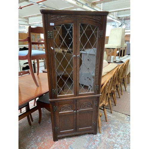 22 - An Old Charm carved oak and lead glazed free standing corner cabinet - approx. 167cm high