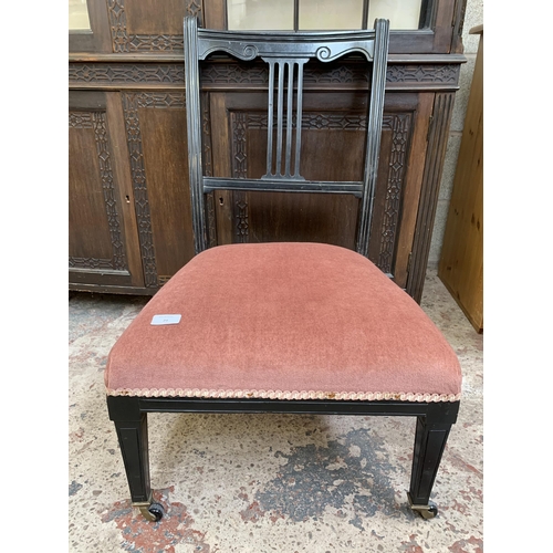 26 - Two late 19th/early 20th century items, one ebonized and fabric upholstered bedroom chair on castors... 