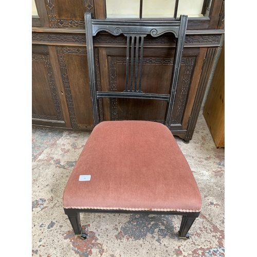 26 - Two late 19th/early 20th century items, one ebonized and fabric upholstered bedroom chair on castors... 