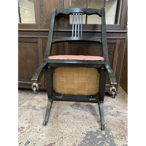 26 - Two late 19th/early 20th century items, one ebonized and fabric upholstered bedroom chair on castors... 