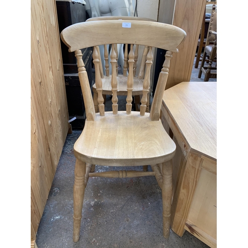 28 - A pair of Victorian style beech spindle back farmhouse dining chairs