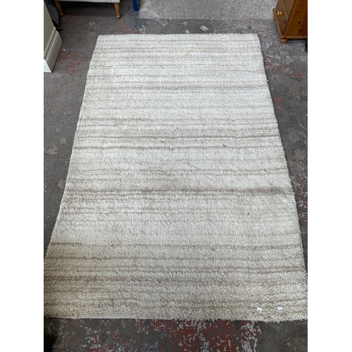 54 - A modern shag pile rug - approx. 245cm x 155cm