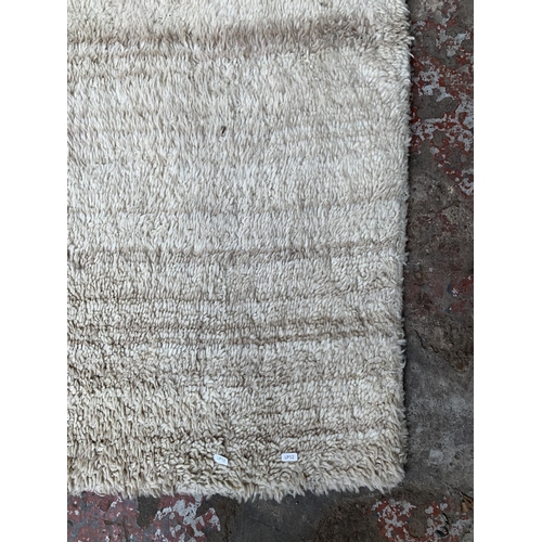 54 - A modern shag pile rug - approx. 245cm x 155cm