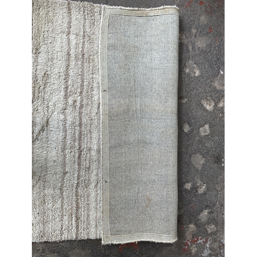 54 - A modern shag pile rug - approx. 245cm x 155cm