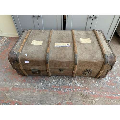 141 - An early 20th century wooden banded fibreboard travel trunk