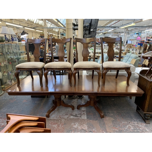 237 - A modern hardwood twin pedestal extending dining table and four chairs - approx. 76cm high x 112cm w... 