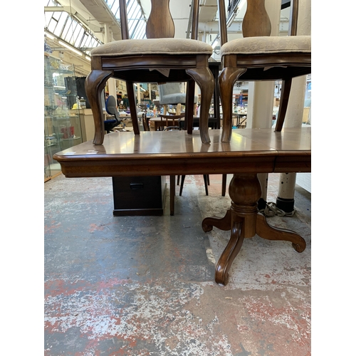 237 - A modern hardwood twin pedestal extending dining table and four chairs - approx. 76cm high x 112cm w... 