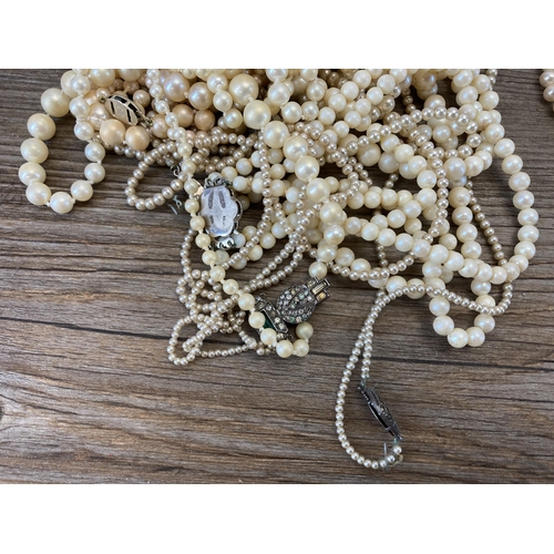 429 - A collection of vintage simulated pearl necklaces with sterling silver clasps