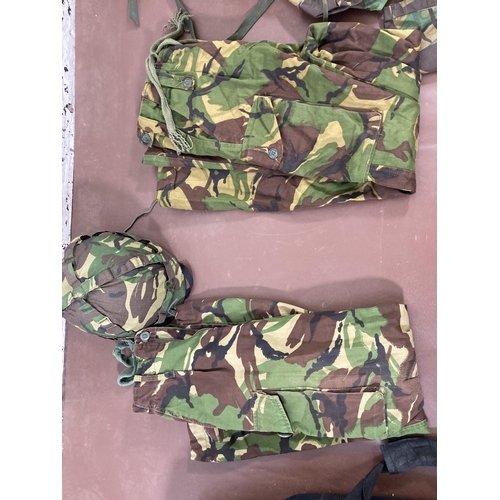 430 - A large quantity of camouflage military uniform and accessories to include Wynnster rucksack, helmet... 