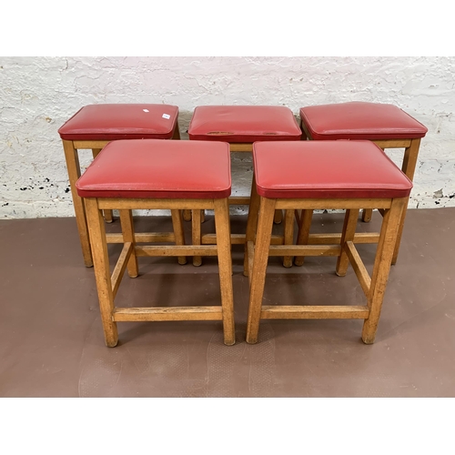 250A - Five mid 20th century beech and red vinyl upholstered stools - approx. 50cm high x 33cm wide x 28cm ... 