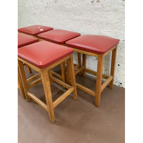 250A - Five mid 20th century beech and red vinyl upholstered stools - approx. 50cm high x 33cm wide x 28cm ... 