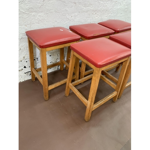 250A - Five mid 20th century beech and red vinyl upholstered stools - approx. 50cm high x 33cm wide x 28cm ... 