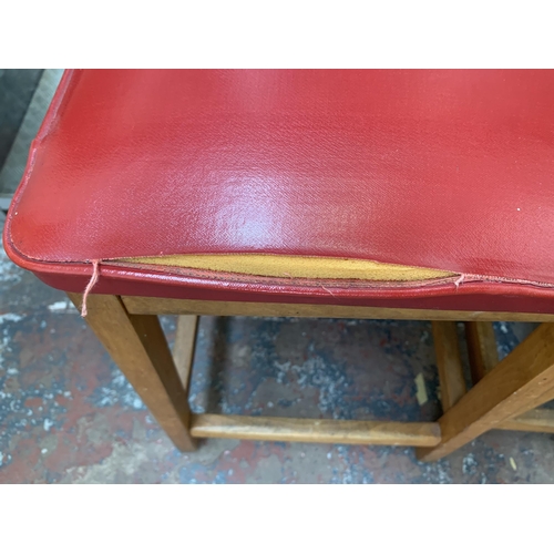 250A - Five mid 20th century beech and red vinyl upholstered stools - approx. 50cm high x 33cm wide x 28cm ... 