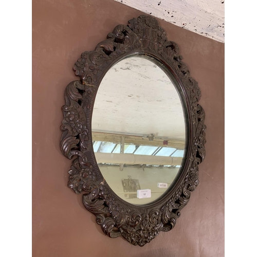 12 - A 19th century carved mahogany framed oval wall mirror - approx. 68cm high x 46cm wide