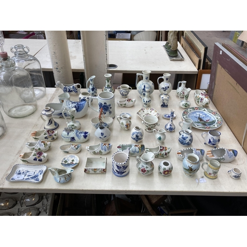 367 - A collection of Delft hand painted ceramics to include jugs, cow creamer, shoe ashtrays etc.