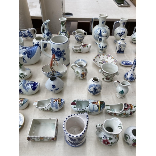 367 - A collection of Delft hand painted ceramics to include jugs, cow creamer, shoe ashtrays etc.