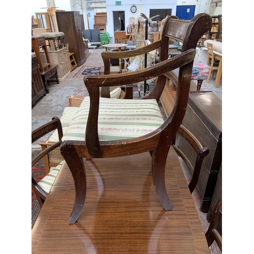 100 - A Georgian style mahogany twin pedestal extending dining table and five chairs