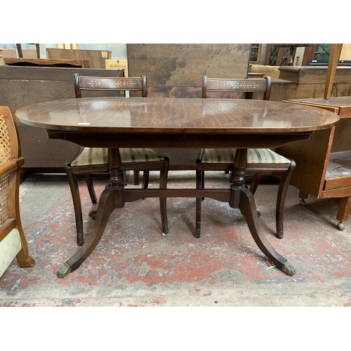 100 - A Georgian style mahogany twin pedestal extending dining table and five chairs