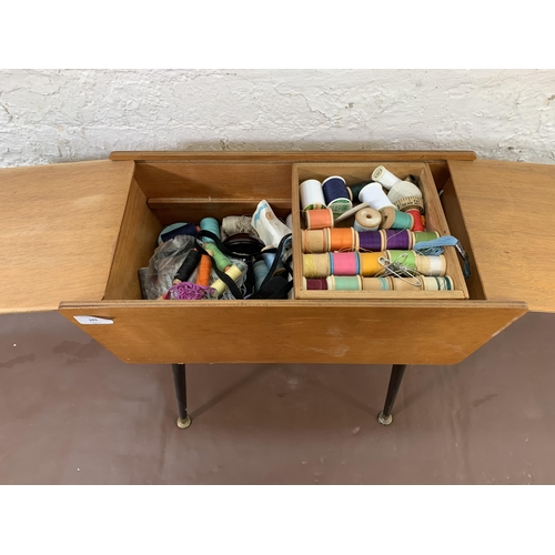 101 - A mid 20th century plywood sewing box on dansette legs - approx. 55cm high x 52cm wide x 24cm deep