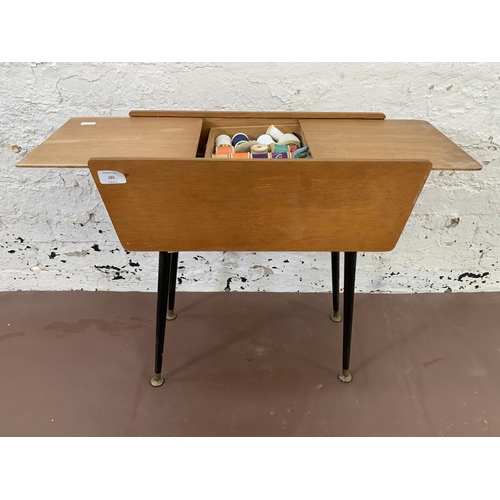 101 - A mid 20th century plywood sewing box on dansette legs - approx. 55cm high x 52cm wide x 24cm deep