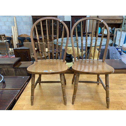 105 - A pair of beech spindle back farmhouse dining chairs