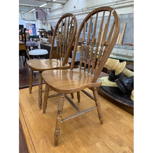 105 - A pair of beech spindle back farmhouse dining chairs