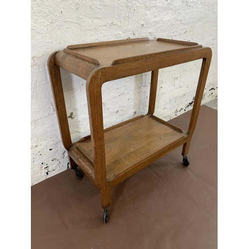 108 - An Art Deco style oak two tier tea trolley - approx. 79cm high x 38cm wide x 74cm deep