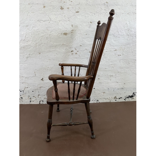 110 - A late 19th/early 20th century carved oak and fabric upholstered spindle back armchair - approx. 112... 