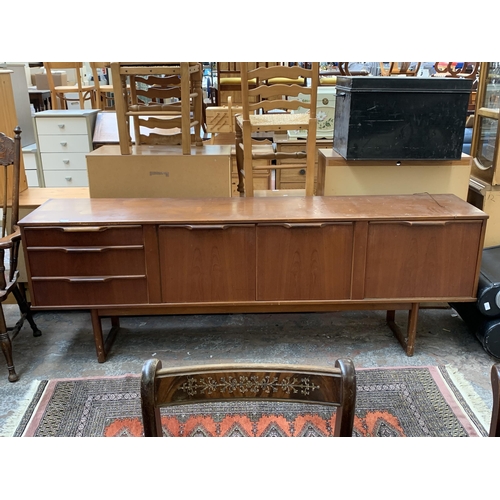 114 - A mid 20th century Stonehill Furniture Ltd teak sideboard - approx. 75cm high x 212cm wide x 44cm de... 