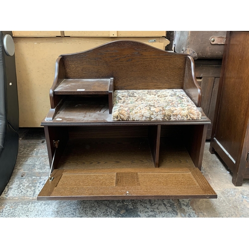 116 - An oak and tapestry upholstered telephone seat