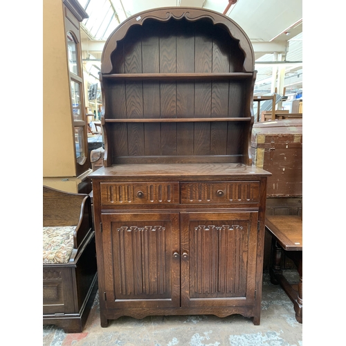 117 - A carved oak linenfold Dutch dresser - approx. 177cm high x 95cm wide x 44cm deep