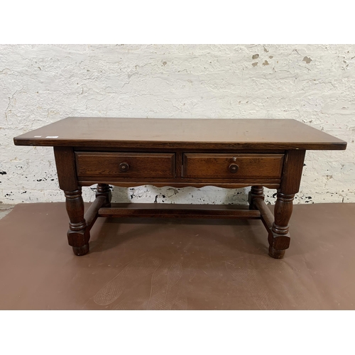 119 - An oak two drawer rectangular coffee table - approx. 50cm high x 49cm wide x 114cm deep