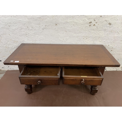 119 - An oak two drawer rectangular coffee table - approx. 50cm high x 49cm wide x 114cm deep